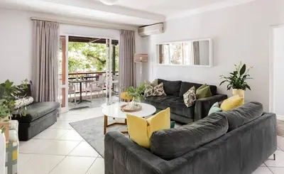 a living room with a couch and a table at Casa Bella Stellenbosch - Jan Cats No 4 in Stellenbosch