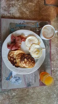 a plate of breakfast food on a table at Angel's Corner in Cape Town