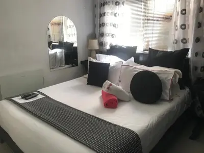a bed with two stuffed animals sitting on it at Turning Point Bed & Breakfast in Cape Town