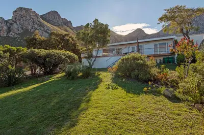 a house with a yard with mountains in the background at Views Views Views in Hermanus