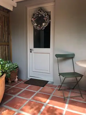 a green chair and a door with a wreath at Elton in Cape Town