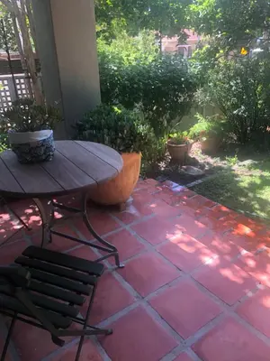 a patio with a table and chairs on a patio at Elton in Cape Town