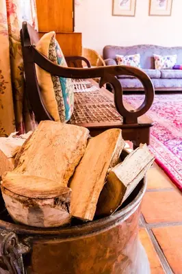 a bucket filled with slices of wood in a room at Die Wasbak in Greyton