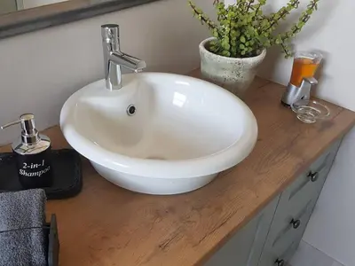 a white sink on a wooden counter in a bathroom at Worcester the Karoo Guest Room in Worcester