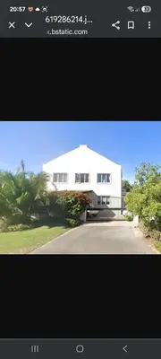 a picture of a white house with a driveway at Whale Tale near Kite Beach in Cape Town