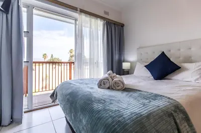 a bedroom with a bed with two towels on it at Cornerstone Guesthouse Alk Van Zyl in Panorama