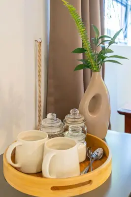 a tray with cups and a vase on a table at Staymore in Stellenbosch
