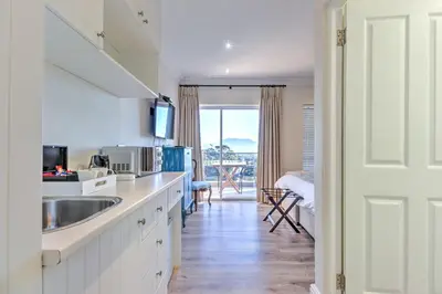 a kitchen with a sink and a counter top at Thyme Wellness Spa and Guesthouse in Cape Town
