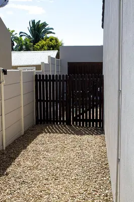 a black fence in front of a house at Princess Holiday Home in Cape Town