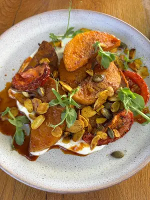 a plate of food with meat and nuts on a table at Lynx Wine Estate in Franschhoek