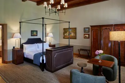 a bedroom with a bed and a television in it at Blaauwklippen Manor by NEWMARK in Stellenbosch