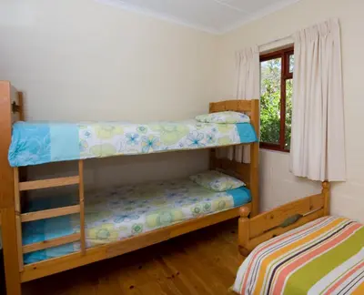 a bedroom with two bunk beds and a window at The Volmoed Trust in Hermanus
