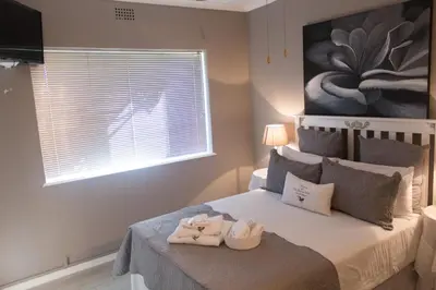 a bedroom with a bed with towels on it at The Vintage Crane Guest House in Caledon