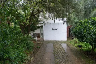 a white building with a sign on the side of it at 4 ON REGENT in Greyton