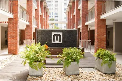 a bench in the middle of a building with plants at Century City Luxury Two Bedroom Apartment in Cape Town