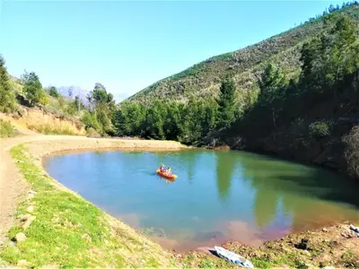 a group of people in a boat in a lake at Vredehoek Guest Farm in Breerivier