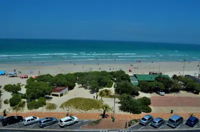 a view of a beach with cars parked in a parking lot at 808 St Tropez in Cape Town