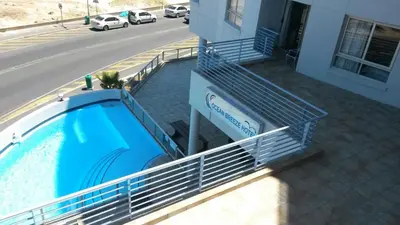a swimming pool on the side of a building at Sunset 786 Holiday Accom-212 in Strand