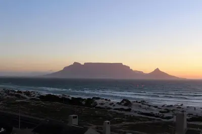 a view of a mountain in the ocean at sunset at 603 Nautica in Cape Town