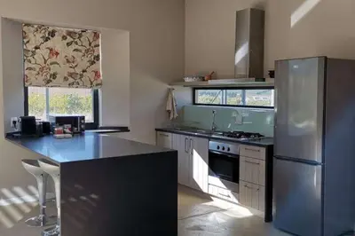 a kitchen with a stainless steel refrigerator and a counter at Farm Stay Winelands in Paarl