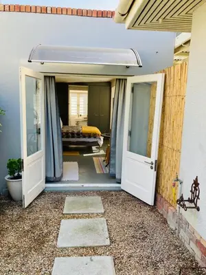an open door to a room with a bed at Modern studio apartment in Cape Town