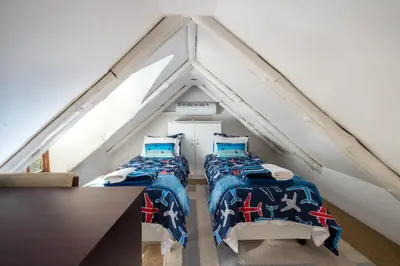 two beds in a room in a attic at Quainton Cottages in Hermanus