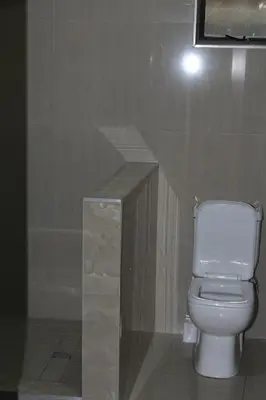 a bathroom with a white toilet and a counter at MO MAJOR in Cape Town