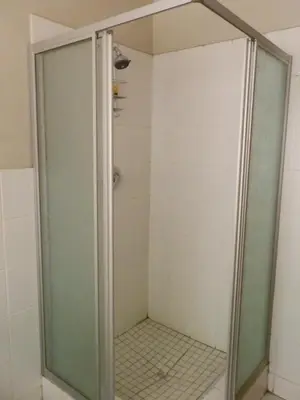 a shower with a glass door in a bathroom at 10 on Fairview B&B in Paarl