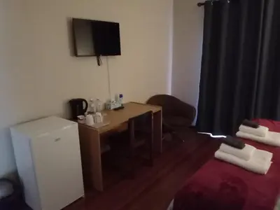 a small room with a desk and a television at 10 on Fairview B&B in Paarl