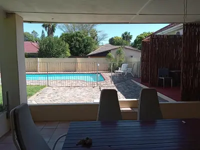 a view of a swimming pool from a patio at 10 on Fairview B&B in Paarl