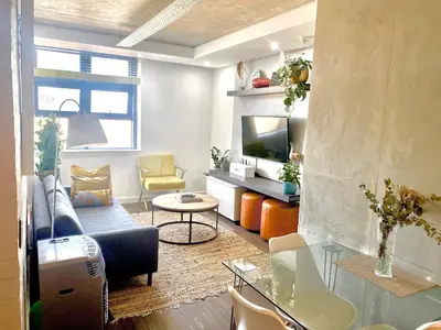 a living room with a couch and a tv at Six One Five at Matrix in Cape Town