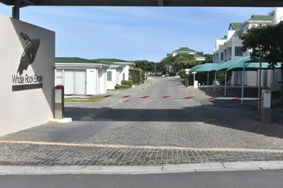 an empty street in a town with buildings at 57 Whale Rock Estate in Hermanus