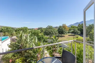 a balcony with chairs and a view of a pool at 4 Piet Retief in Stellenbosch