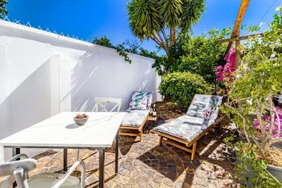 a patio with a white table and two chairs at La Bonne Auberge in Somerset West