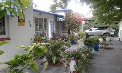 a garden in front of a house with flowers at Canberra on Greenwood in Cape Town