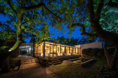 a house with a lot of windows at night at Heron House at Bartholomeus Klip in Hermon