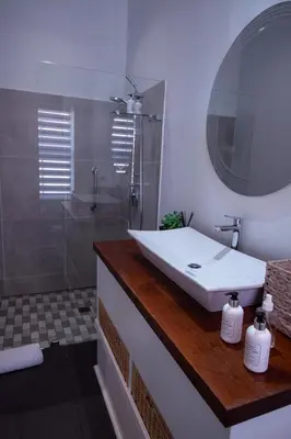 a bathroom with a sink and a shower at LA RÉVERIE in Franschhoek