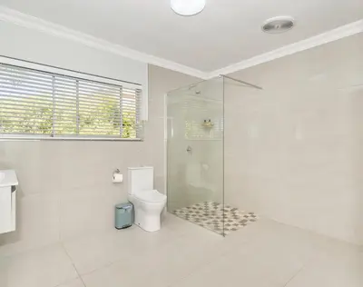 a bathroom with a shower and a toilet at Ocean Way Villas - Self Catering in Cape Town