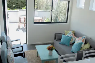 a living room with a couch and a table at The Yacht in Hermanus