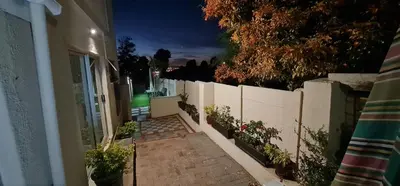 a hallway of a house at night with a fence at Walters Lane Economy Apartment 1 - No Loadshedding in Cape Town