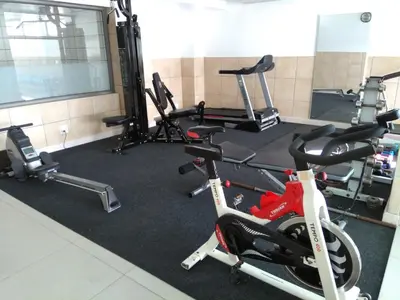 a gym with several exercise bikes in a room at Hibernian Towers 807, Beach Road, Strand in Strand