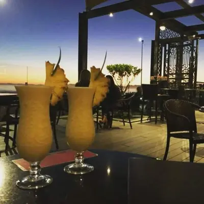 two vases on a table with some drinks on it at Hibernian Towers 807, Beach Road, Strand in Strand