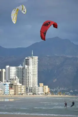 two people are kite surfing in the water on the beach at Hibernian Towers 807, Beach Road, Strand in Strand