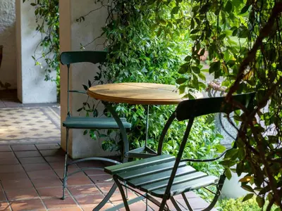 a table and two chairs and a table and a bench at Villa Puccini in Cape Town