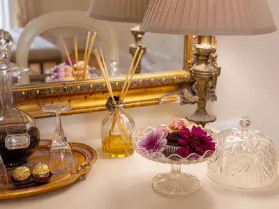 a table with a mirror and a bowl of flowers at Villa Puccini in Cape Town
