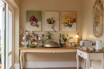 a room with paintings of fruit on the wall at Villa Puccini in Cape Town