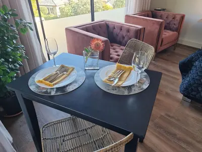 a black table with two plates of food on it at Vrede Selfcatering in Somerset West