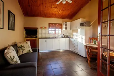 a kitchen with a couch and a table in a room at Vergenoegd in Brandwacht
