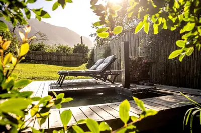a chair sitting on a wooden deck in a yard at Hemel 'N Aarde Stud in Hermanus