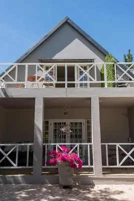 a house with pink flowers in a pot at Baruch Guest House Rhodes in Stellenbosch